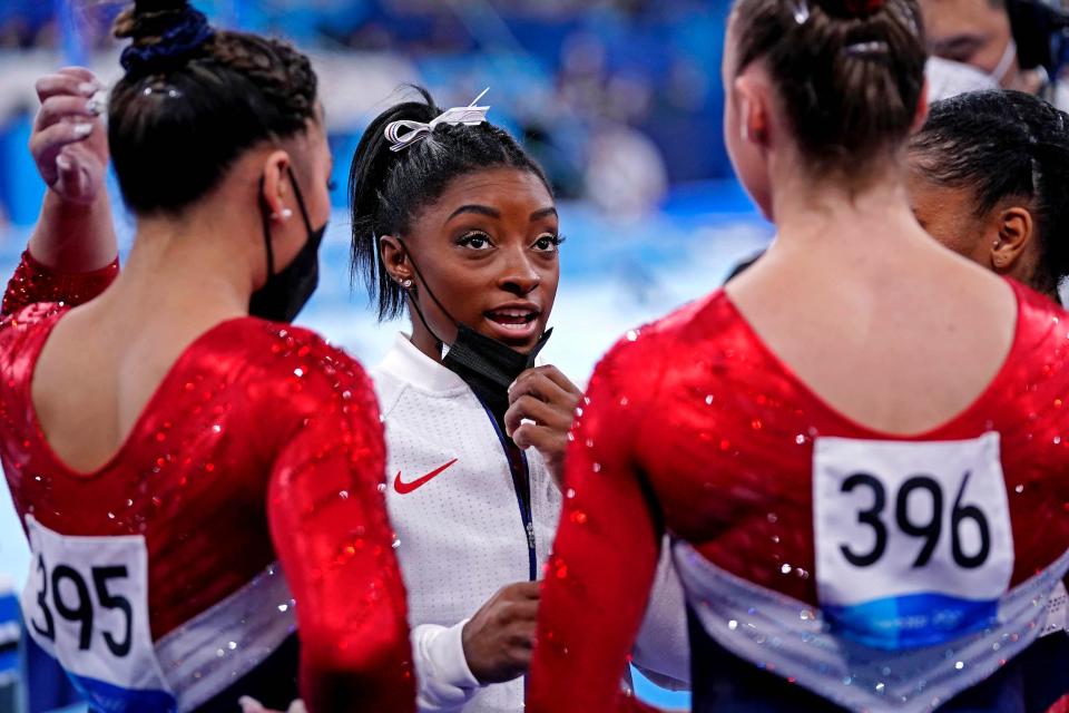 Simone Biles chats with her Team USA teammates.