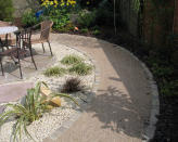 <p> Landscaping with gravel is one of the cheapest and quickest ways to create a DIY walkway in a garden. Gravel is also very versatile. You can choose from a huge range of colors including white, buff, gray, mixed and soft red/pink. Even cheaper, especially if bought in bulk, is crushed stone such as limestone. </p> <p> Gravel is very versatile; warm-colored gravel with yellow/orange tones offers a Mediterranean gravel garden feel, while white will be more contemporary. Also under the heading of ‘gravel’ comes reclaimed materials such as crushed shells, which are perfect for a maritime garden. </p> <p> 'Gravel is a great option financially and is super simple to construct,' says Rowan Cripps. 'Whether you opt for a meandering path or carefully curated layouts, gravel makes maintaining a garden easy and low maintenance.' </p> <p> Another bonus of using gravel for your cheap DIY garden path ideas is that it's easy to refresh it; when it starts looking a bit battered, simply add more gravel. </p>