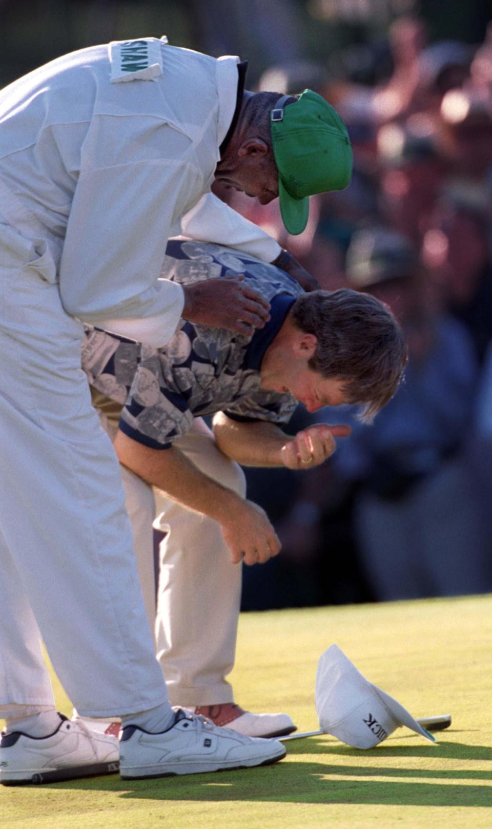 Ben Crenshaw is comforted by caddie Carl Jackson after winning the 1995 Masters Tournament at Augusta National Golf Club.