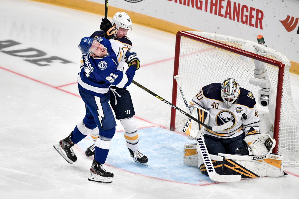 Tampa's Steven Stamkos tries to score past Buffalo's Rasmus Dahlin and goalie Carter Hutton during a NHL Global Series hockey match between the Buffalo Sabres and Tampa Bay Lightning at the Globen Arena, in Stockholm Sweden, Saturday, Nov. 9, 2019. ( Jessica Gow/TT News Agency via AP)