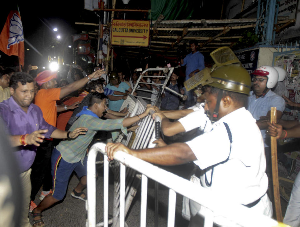Supporters of Bharatiya Janata Party (BJP) break police barricades during clashes outside the Calcutta University in Kolkata, India, Tuesday, May 14, 2019. Rival political supporters clashed with rocks and sticks during an election rally by the Hindu nationalist party BJP leaving several people injured and a university college vandalized. (AP Photo)