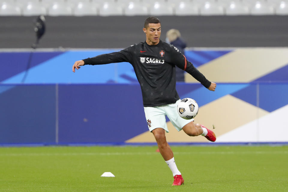 Cristiano Ronaldo kicks a ball during warmups.