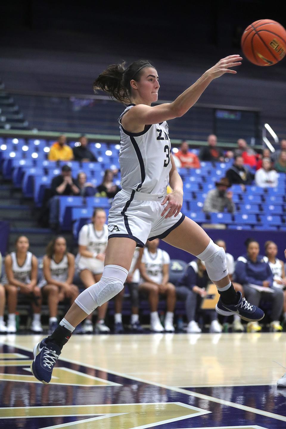 University of Akron's Reagan Bass makes a leaping save on a loose ball against Bellarmine on Dec. 21, 2023, in Akron.
