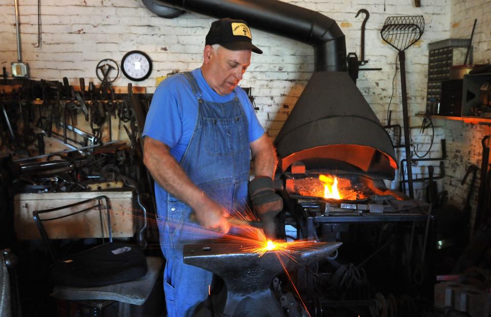 Third-generation blacksmith James Ellis works his forge in his new location behind the Coast Guard Museum, off Route 6A in Barnstable.