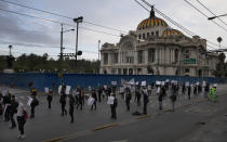 Artists protest outside the Fine Arts Palace to demand financial aid amid the economic slowdown brought by partial lockdowns to contain the spread of COVID-19 in Mexico City, Tuesday, Aug. 11, 2020. The National Artistic Resistance (RAN) organization is asking the government for artists to be included in rescue budgets and given social support. (AP Photo/Marco Ugarte)