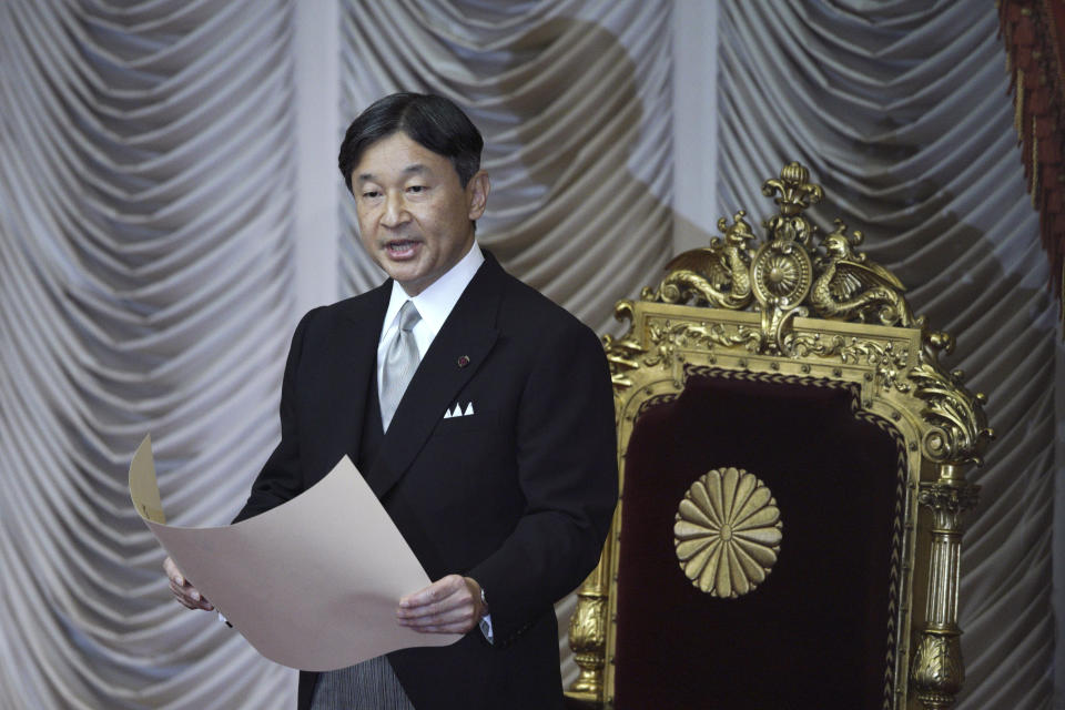 Japan's Emperor Naruhito reads a statement to open formally an extraordinary session at the upper house of parliament in Tokyo Friday, Oct. 4, 2019. (AP Photo/Eugene Hoshiko)