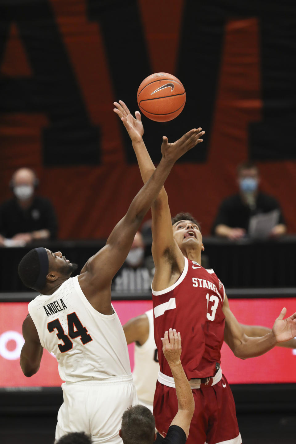 Stanford's Oscar da Silva (13) and Oregon State's Rodrigue Andela (34) go up for the tip-off during the first half of an NCAA college basketball game in Corvallis, Ore., Monday, Jan. 4, 2021. (AP Photo/Amanda Loman)