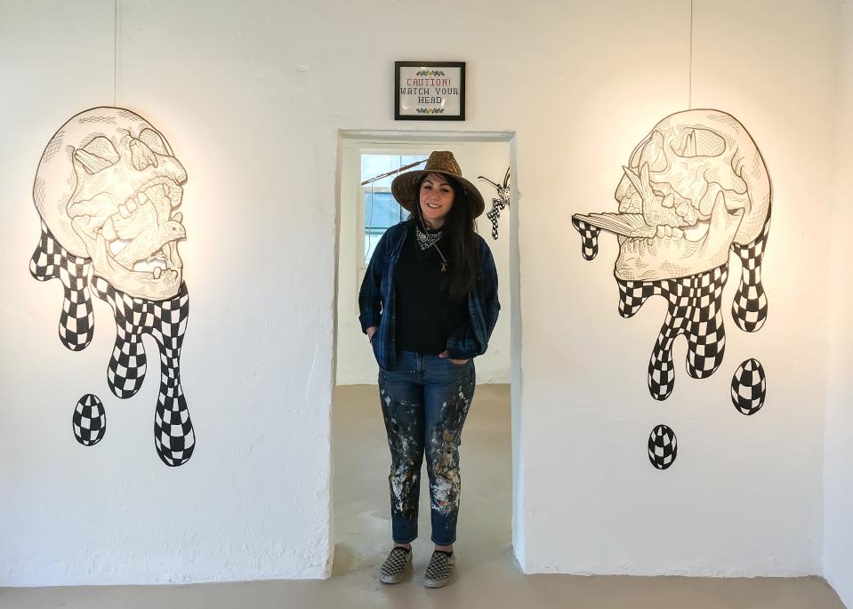 El Paso artist Christin Apodaca’s stands between art pieces that were part of her exhibit, “Are you OK?” It was held at Galería Lincoln at 3915 Rosa Ave. She is shown March 20, 2021.