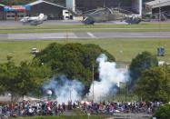 Riot security forces fire tear gas at opposition supporters from an air force base during clashes at a rally against Venezuelan President Nicolas Maduro's government in Caracas, Venezuela June 22, 2017. REUTERS/Christian Veron