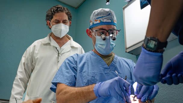 PHOTO: Air Force Henry Foerster, center, performs a dental exam alongside Master Sgt. Adolfo Figueroa, on a nurse assigned to Hospital Regional de Occidente in Quetzaltenango, Guatemala, Aug. 26, 2022. (Staff Sgt. Dustin Biven/Defense Media Activity/Army)