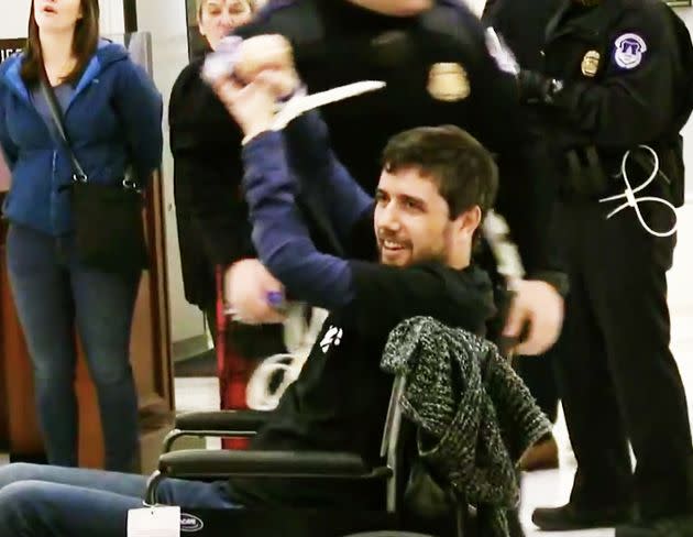 Barkan raises his fists in triumph after getting arrested while protesting Trump's tax proposals on his 34th birthday.