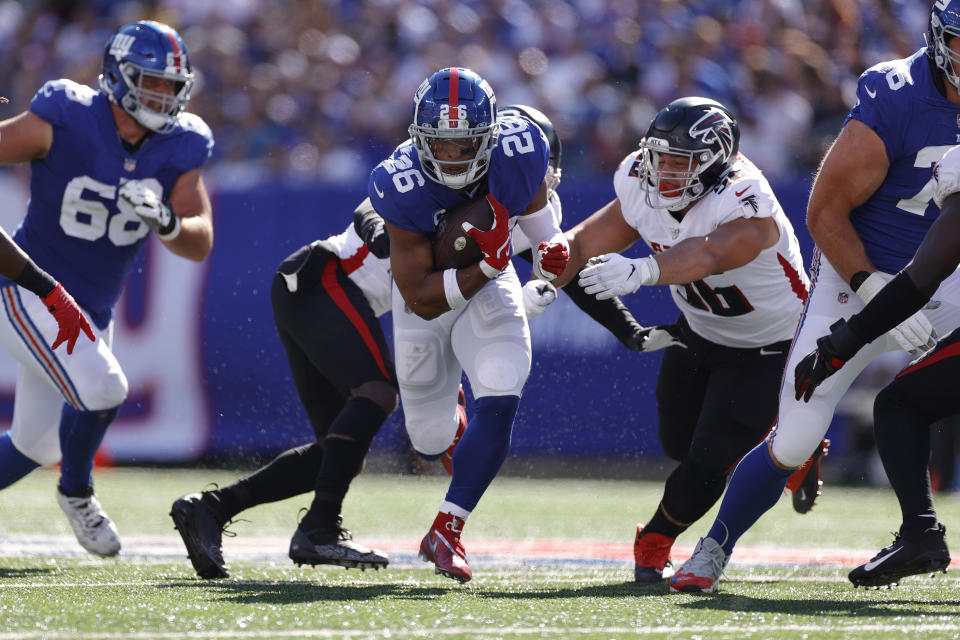 EAST RUTHERFORD, NEW JERSEY - SEPTEMBER 26: Saquon Barkley #26 of the New York Giants runs the ball during the third quarter in the game against Atlanta Falcons at MetLife Stadium on September 26, 2021 in East Rutherford, New Jersey. (Photo by Sarah Stier/Getty Images)