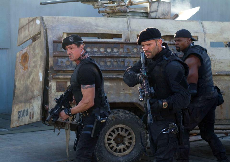 This film image released by Lionsgate shows, from left, Sylvester Stallone, Jason Statham and Terry Crews in a scene from