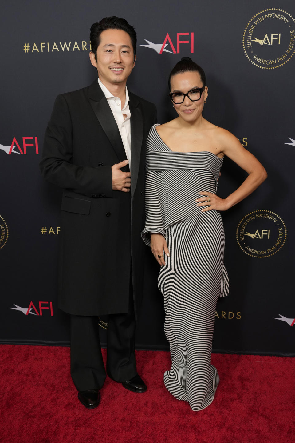 Steven Yeun, left, and Ali Wong arrive at the AFI Awards on Friday, Jan. 12, 2024, at the Four Seasons Beverly Hills in Beverly Hills, Calif. (AP Photo/Chris Pizzello)