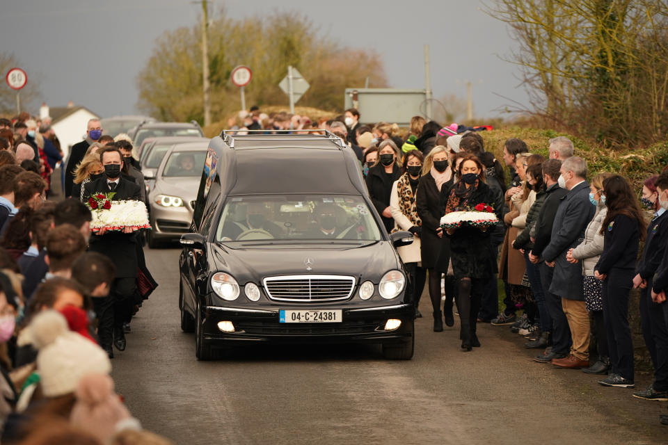 Mourners walk beside the hearse as the cortege arrives at St Brigid's Church, Mountbolus, Co Offaly, for the funeral of Ashling Murphy, who was murdered in Tullamore, Co Offaly last Wedensday. 23-year-old Ashling, a primary school teacher and a talented musician, was found dead after going for a run on the banks of the Grand Canal in Tullamore.. Picture date: Tuesday January 18, 2022.