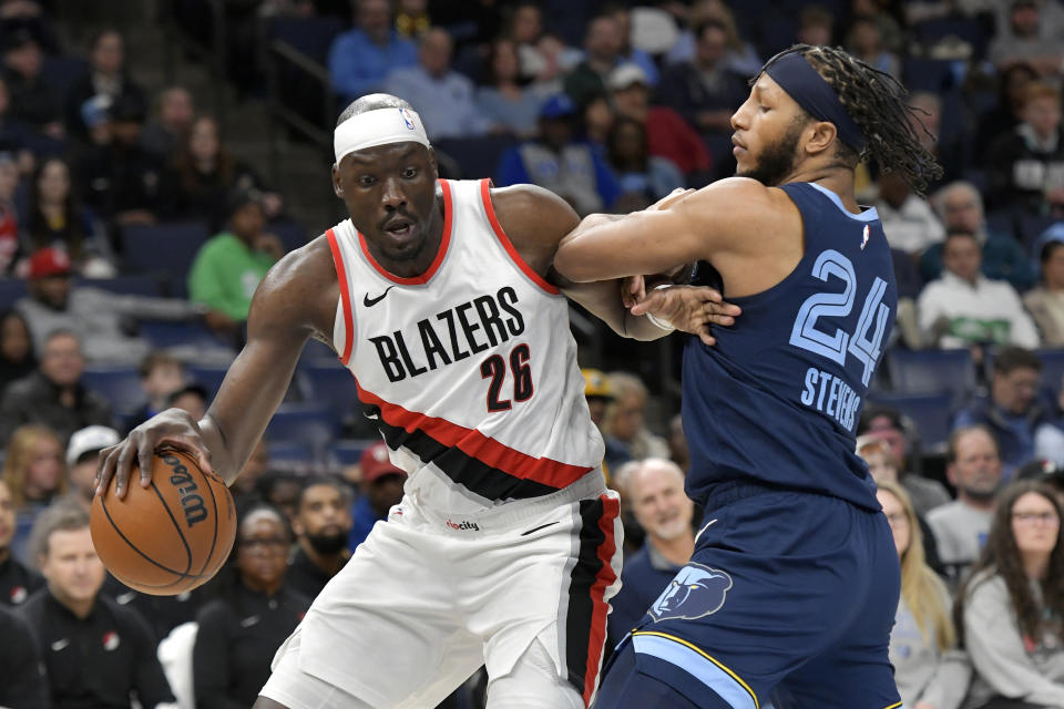 Portland Trail Blazers center Duop Reath (26) handles the ball against Memphis Grizzlies forward Lamar Stevens (24) in the first half of an NBA basketball game Friday, March 1, 2024, in Memphis, Tenn. (AP Photo/Brandon Dill)