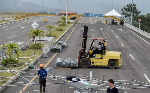 Workers begin to assemble stages for a Live Aid-style concert organised by British billionaire Richard Branson - Credit: &nbsp;LUIS ROBAYO/&nbsp;AFP