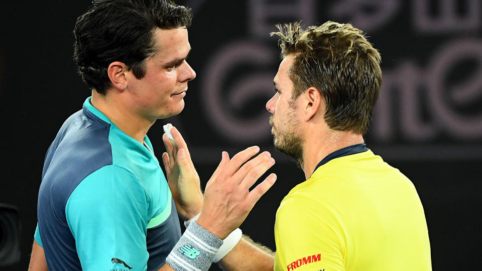 Milos Raonic and Stan Wawrinka embrace at the net. (Photo by Quinn Rooney/Getty Images)