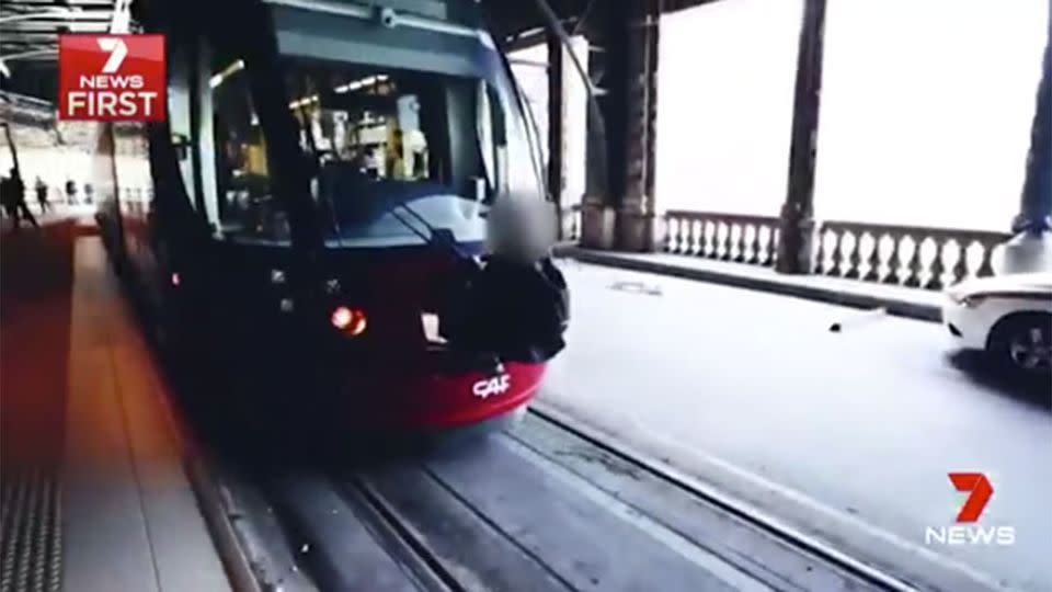 A person riding a train, illegally. Source: 7 News