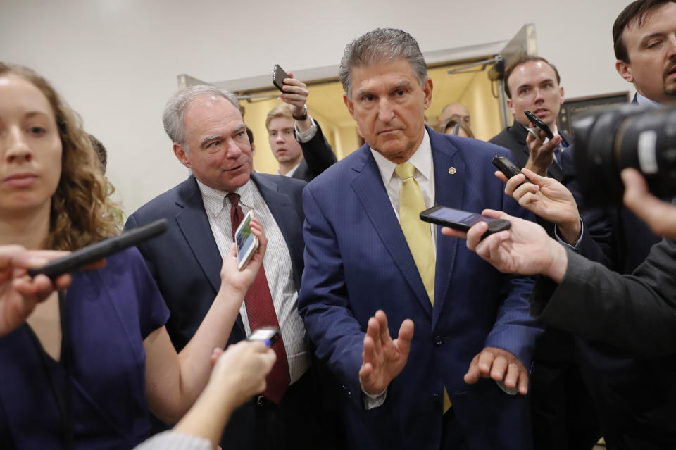 Sen. Joe Manchin, D-W. Va., right, and Sen. Tim Kaine, D-Va., left, walk together after viewing the FBI supplemental background report on Supreme Court Justice nominee Brett Kavanaugh in the SCIF in the Capitol in Washington, Friday, Oct. 5, 2018, before the procedural vote on the Senate floor later in the morning. (AP Photo/Pablo Martinez Monsivais)