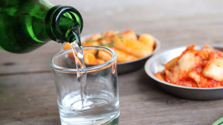 soju pouring from bottle glass