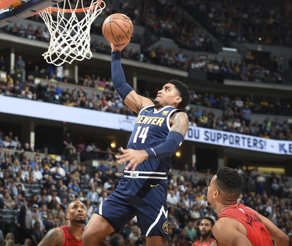 Denver Nuggets guard Gary Harris, center, goes up for a basket between Portland Trail Blazers guards Damian Lillard, back, and CJ McCollum in the first half of Game 7 of an NBA basketball second-round playoff series Sunday, May 12, 2019, in Denver. (AP Photo/John Leyba)