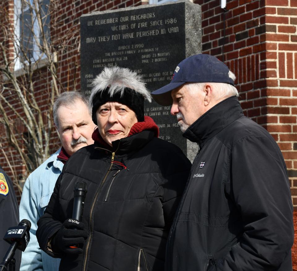 The mother of fallen Worcester Firefighter Christopher Roy, Michele Roy, with husband Ron Roy, right, and William T. Breault, chairman of the Main South Alliance for Public Safety, speaks during the ceremony.