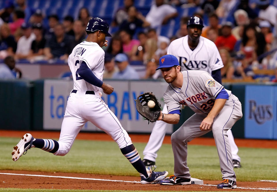 ST. PETERSBURG - JUNE 13: First baseman Ike Davis #29 of the New York Mets takes the throw at first as outfielder B.J. Upton #2 of the Tampa Bay Rays gets back safely during the game at Tropicana Field on June 13, 2012 in St. Petersburg, Florida. (Photo by J. Meric/Getty Images)