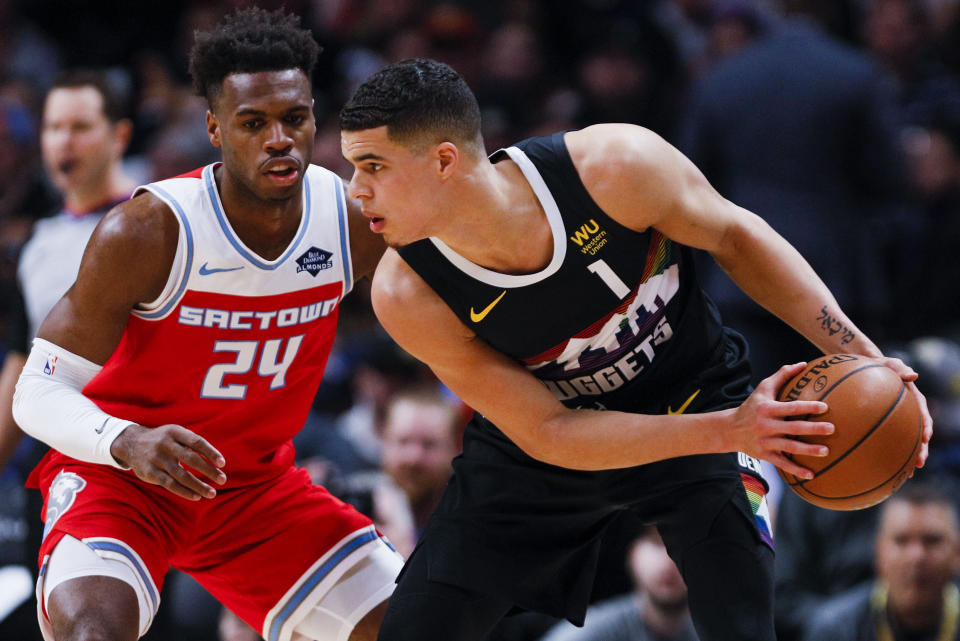 Sacramento Kings guard Buddy Hield (24) defends Denver Nuggets forward Michael Porter Jr. (1) in the first half of an NBA basketball game Sunday, Dec. 29, 2019 in Denver. (AP Photo/Joe Mahoney)