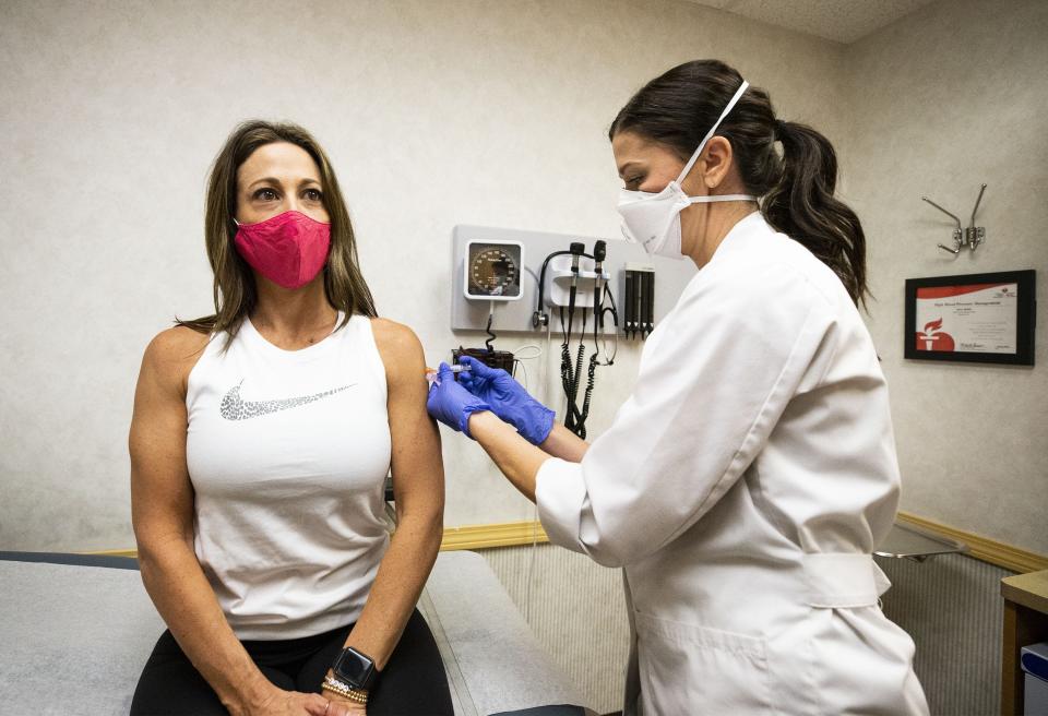 Melina Macchiavelli receives a flu shot from Elizabeth Lillenurms, a nurse practitioner, at the CVS MinuteClinic near 16th Street and Camelback Road in Phoenix.