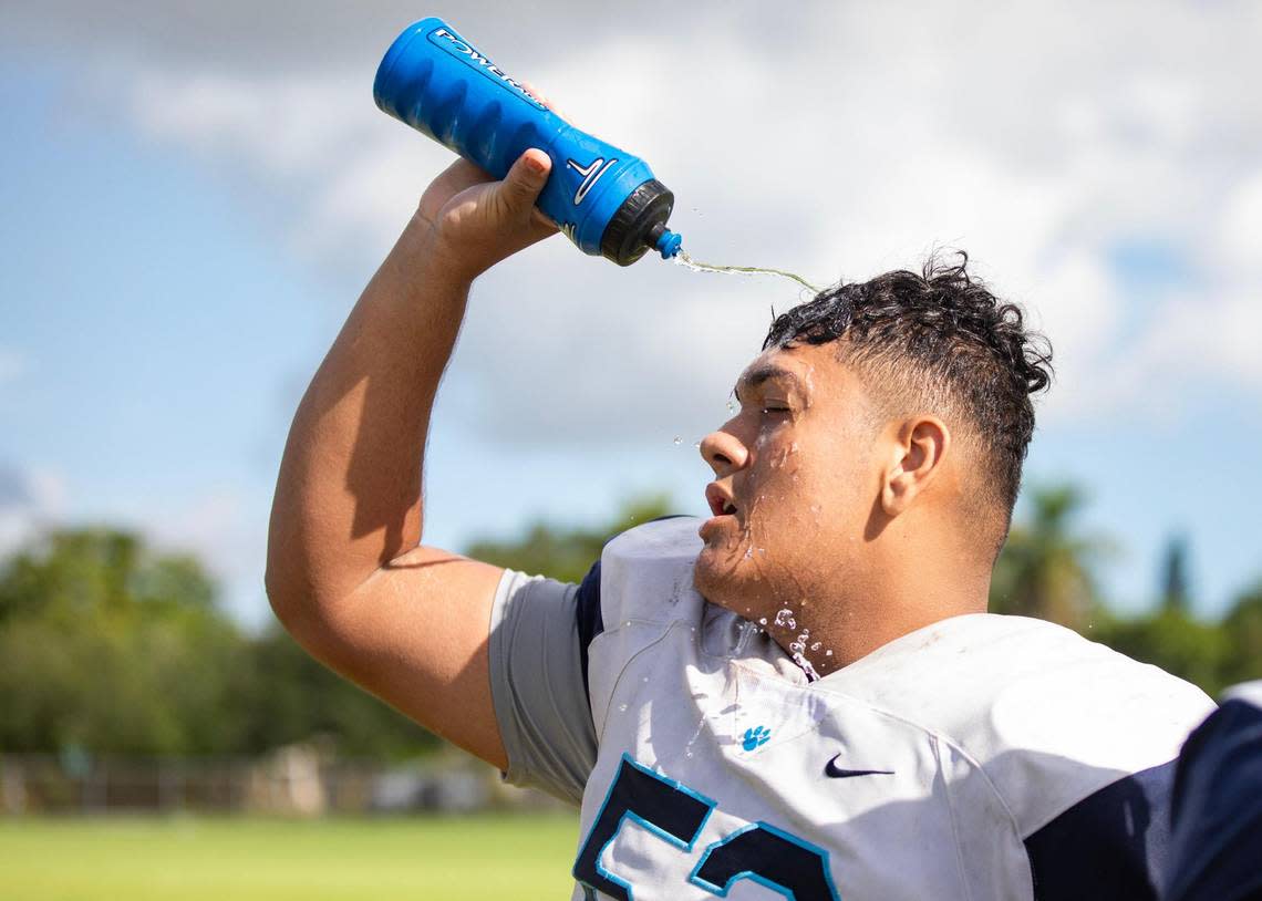 Johnny Mejia, offensive lineman, pours water on his head to cool down during the Palmetto Panthers football practice on Monday, Aug. 7, 2023 in Pinecrest, Fla.