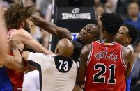 <p>Toronto Raptors forward Serge Ibaka (9) strikes out at Chicago Bulls center Robin Lopez (8) during a scuffle during the second half of an NBA basketball game in Toronto, Tuesday, March 21, 2017. (Frank Gunn/The Canadian Press via AP) </p>