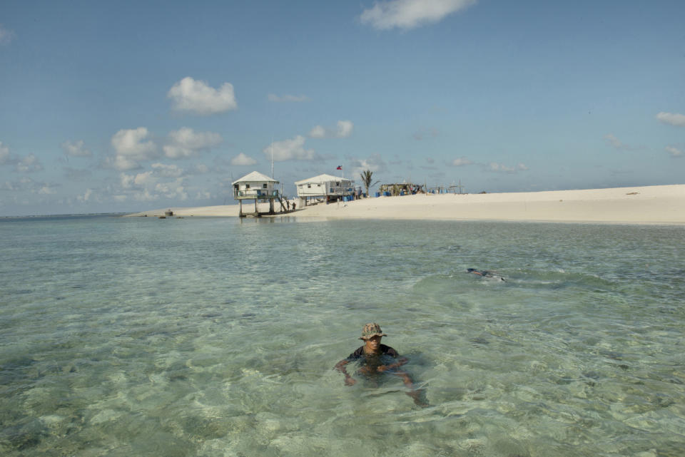 A soldier takes a dip in the water off the Philippine controlled Flat Island, May 8, 2016.