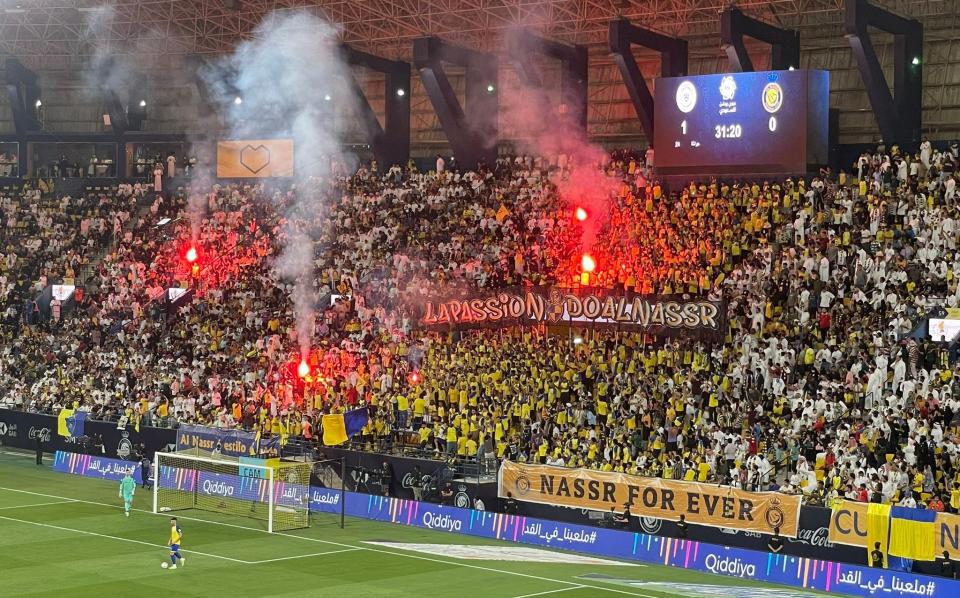 Flares are let off in the crowd - Sam Farley for The Telegraph