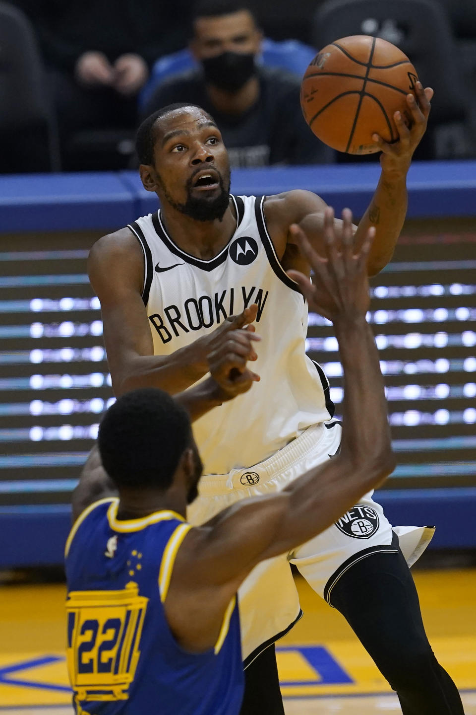 Brooklyn Nets forward Kevin Durant, top, shoots asGolden State Warriors forward Andrew Wiggins defends during the first half of an NBA basketball game in San Francisco, Saturday, Feb. 13, 2021. (AP Photo/Jeff Chiu)