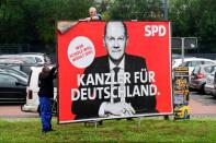 Workers remove election campaign posters after general election in Germany