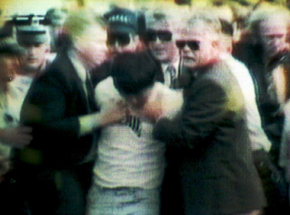 SYDNEY, AUSTRIA:  In this photo taken from a television broadcast, a man (C) is arrested in Sydeney, Australia, after he fired shots from a starter's pistol at Britain's Prince Charles 26 January 1994 during celebrations to mark Australia Day. Australia's Channel Nine television news identified the attacker as David Kang, an Australian-born ethnic Chinese student, and Prince Charles was not hurt in the attack. (Photo credit should read THOMAS CHENG/AFP via Getty Images)