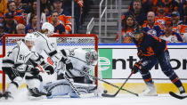 Los Angeles Kings goalie Jonathan Quick, center, grabs for a lose puck as Edmonton Oilers left wing Evander Kane tries to get it into the net during the first period in Game 7 of a first-round series in the NHL hockey Stanley Cup playoffs Saturday, May 14, 2022, in Edmonton, Alberta. (Jeff McIntosh/The Canadian Press via AP)