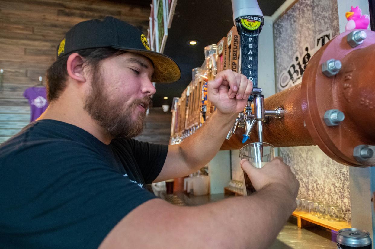 Eugene Valley pours a beer at Big Top Brewing Company in downtown Pensacola on Monday, March 13, 2023.