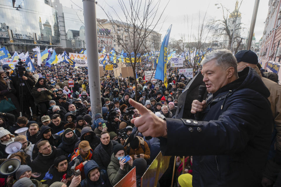 Former Ukrainian President Petro Poroshenko, right, speaks to a crowd in front of a court building prior to a court session, in Kyiv, Ukraine, Wednesday, Jan. 19, 2022. A Kyiv court is due to rule on whether to remand Poroshenko in custody pending investigation and trial on treason charges he believes are politically motivated. (AP Photo/Efrem Lukatsky)