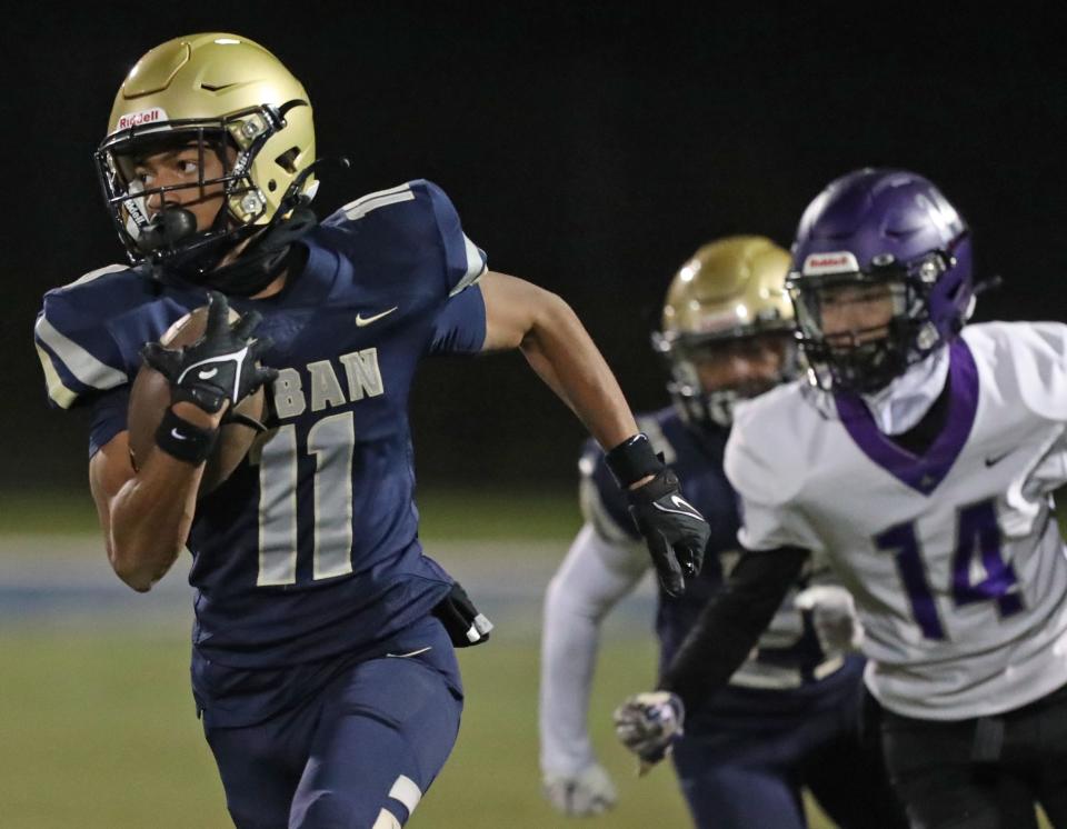 Hoban's Elbert Hill IV outruns Barberton's Trent DeWitt to score a touchdown during a Division II regional quarterfinal, Friday, Nov. 3, 2023.