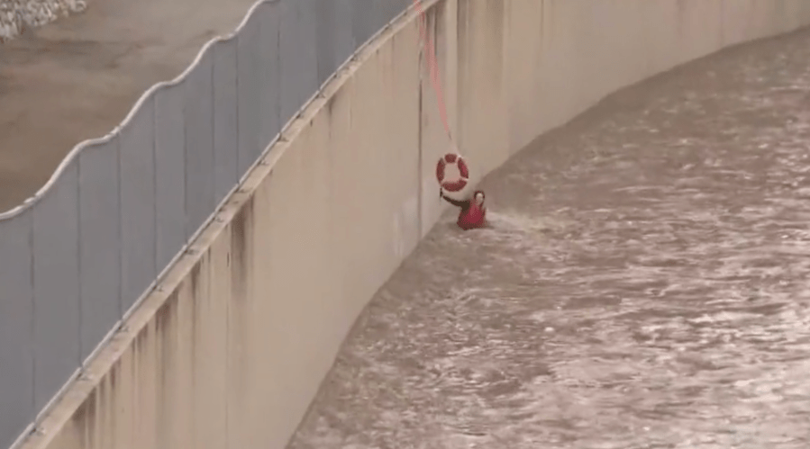 Firefighters rescue woman from storm-flooded L.A. River