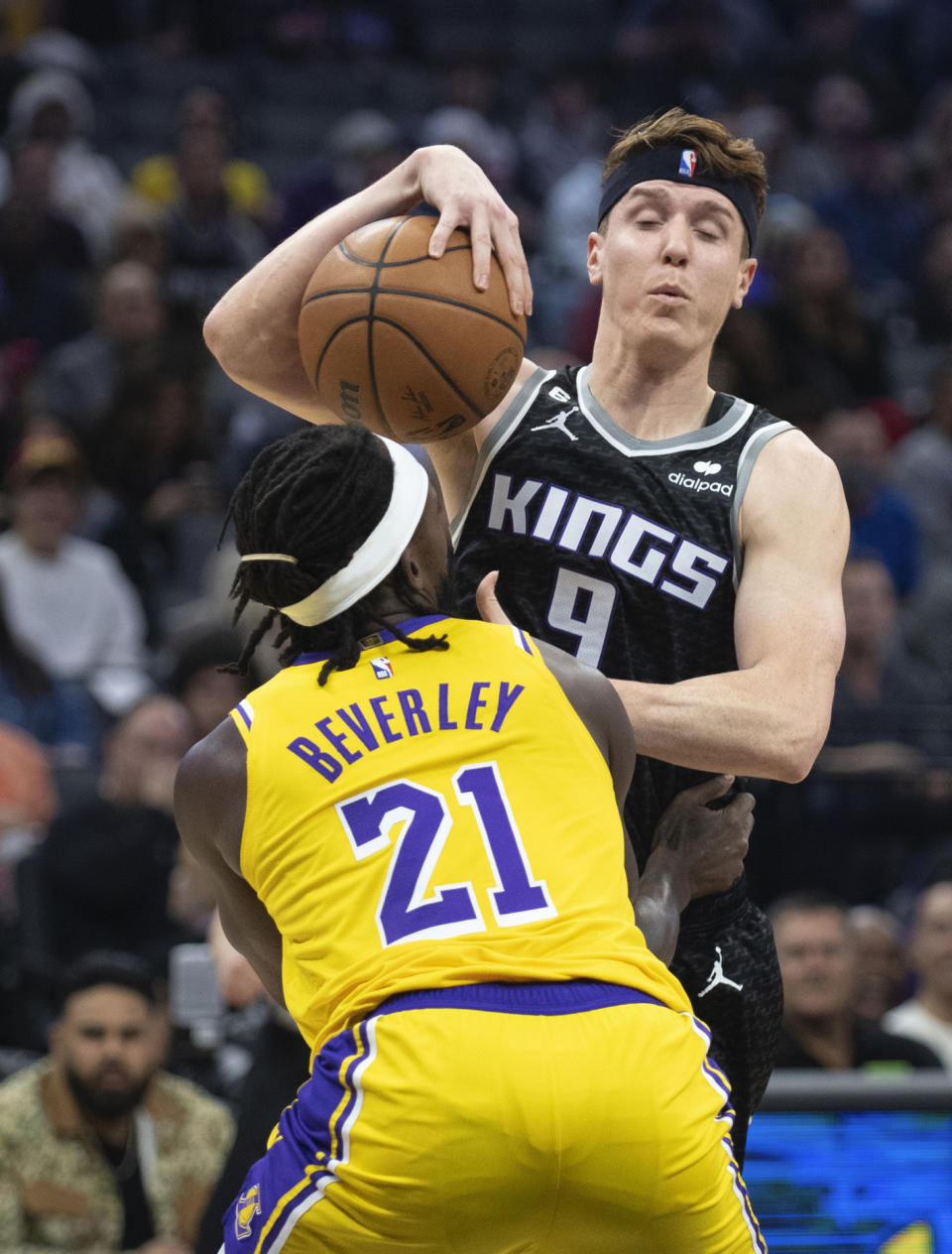 Sacramento Kings guard Kevin Huerter (9) is fouled by Los Angeles Lakers guard Patrick Beverley (21) during the first quarter of an NBA basketball game in Sacramento, Calif., Wednesday, Dec. 21, 2022. (AP Photo/José Luis Villegas)