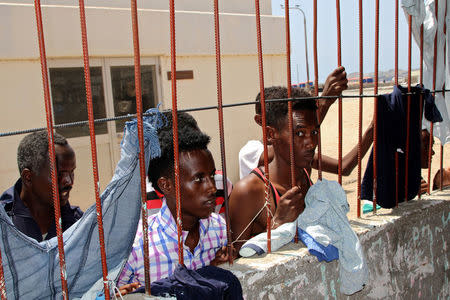 African migrants look on from behind bars in a deportation center in Aden, Yemen March 17, 2018. Picture taken March 17, 2018. REUTERS/Fawaz Salman