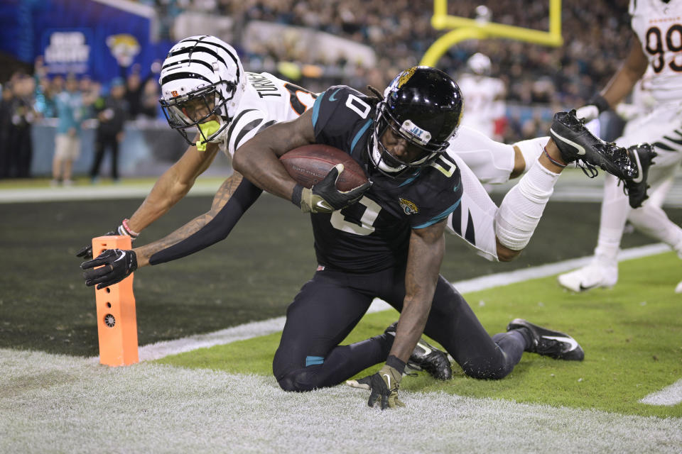 Jacksonville Jaguars wide receiver Calvin Ridley (0) is knocked out of bounce short of the goal line by Cincinnati Bengals cornerback DJ Turner II (20) during the second half of an NFL football game, Monday, Dec. 4, 2023, in Jacksonville, Fla. (AP Photo/Phelan M. Ebenhack)