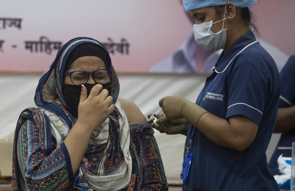 A health worker administers the vaccine for COVID-19 in Mumbai, India, Thursday, Sept. 2, 2021. (AP Photo/Rafiq Maqbool)