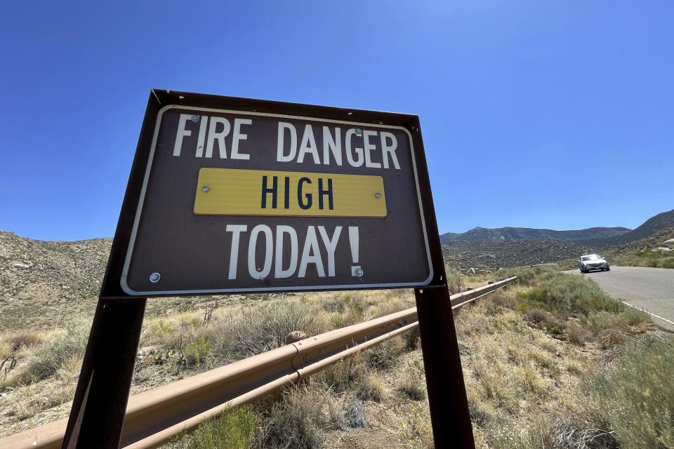A sign warns that fire danger is high in the foothills of the Sandia Mountains that border Albuquerque, N.M.