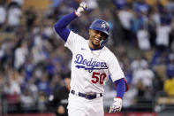 Los Angeles Dodgers' Mookie Betts celebrates as he rounds third after hitting a solo home run during the third inning of a baseball game against the Colorado Rockies Tuesday, July 5, 2022, in Los Angeles. (AP Photo/Mark J. Terrill)