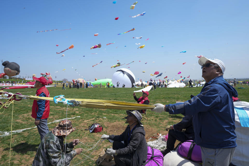 A participant flies a kite at the 41st International Kite Festival in Weifang, Shandong Province of China, Saturday, April 20, 2024. (AP Photo/Tatan Syuflana)