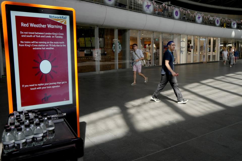 FILE - A sign at King's Cross railway station warns of train cancellations due to the heat in London, July 19, 2022. Earth’s fever persisted last year, not quite spiking to a record high but still in the top five or six warmest on record, government agencies reported Thursday, Jan. 12, 2023. (AP Photo/Kirsty Wigglesworth, File)